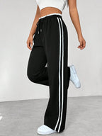 Sportbroek met zijstrepen en elastische taille voor dames in zwart